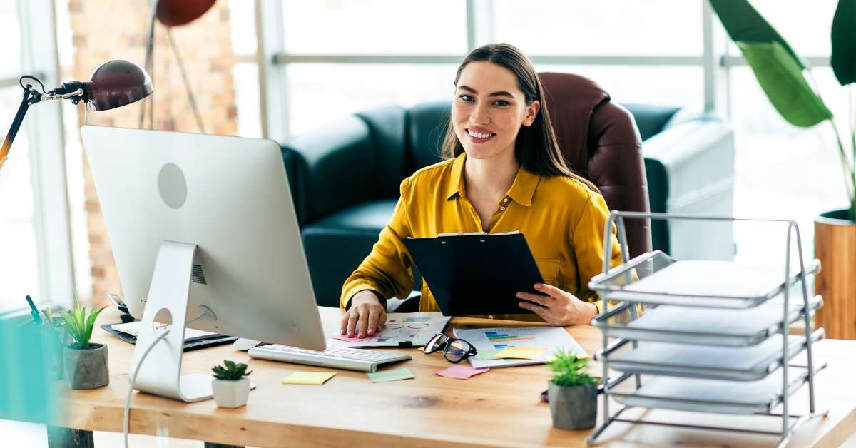 smiling businesswoman sitting at desk