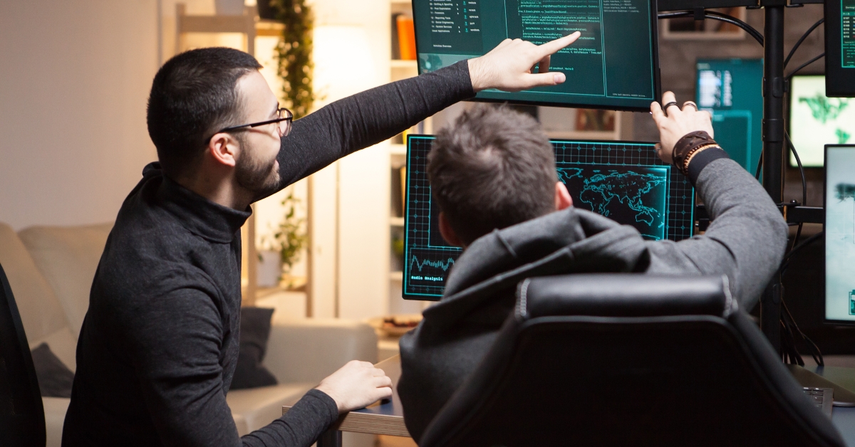 hackers pointing on computer screens 