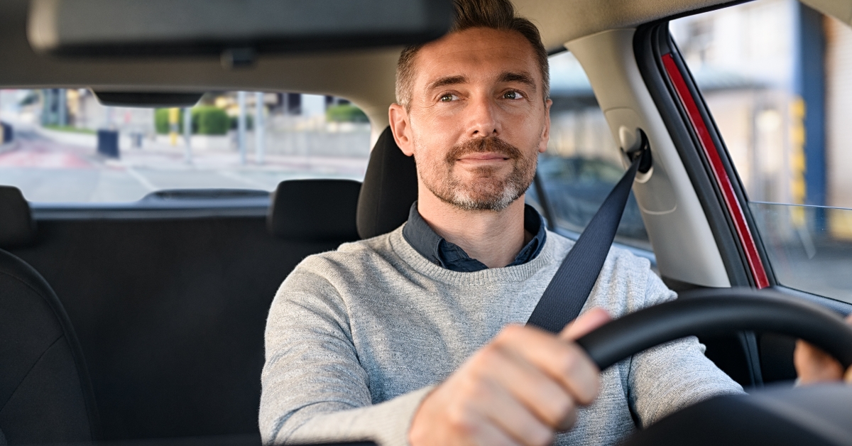 happy mature man driving car 