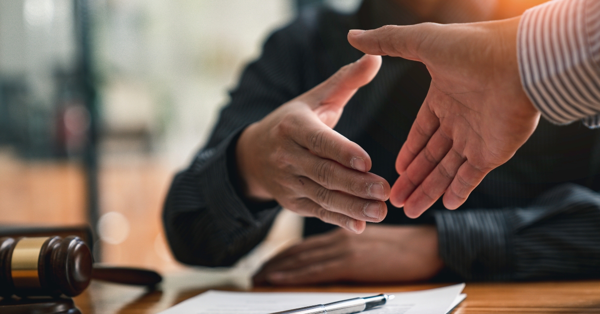 Lawyers shake hands with business people
