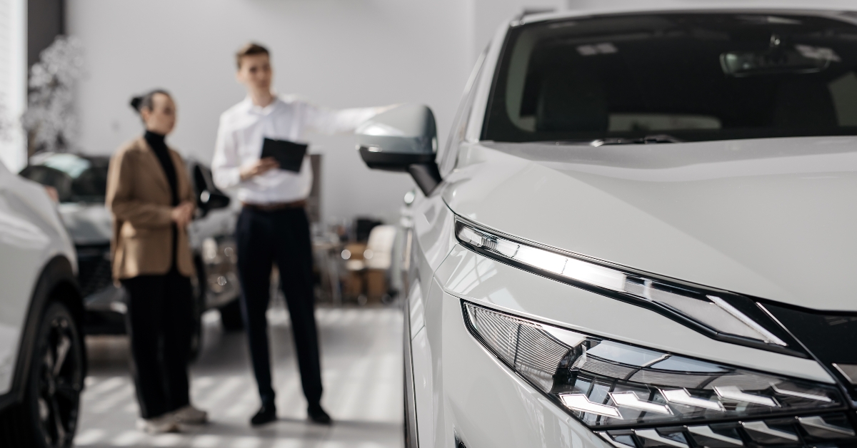 car dealer advises a customer on buying a new car