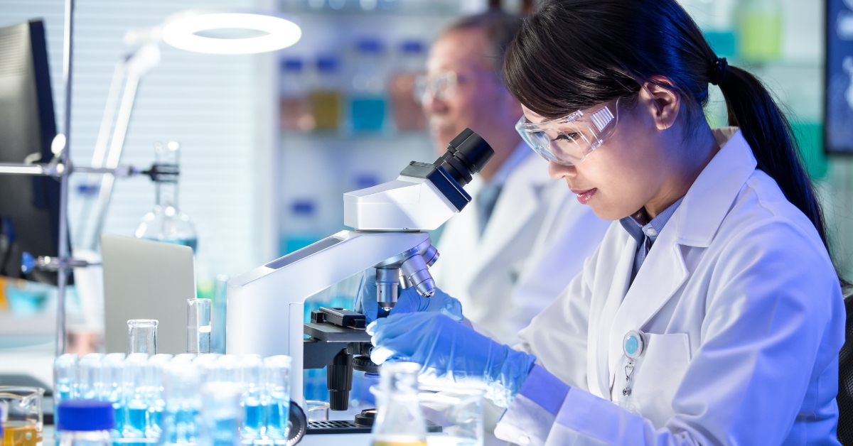 female scientist use microscope