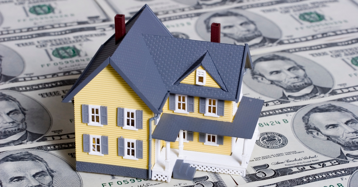 a small house and dollar bills