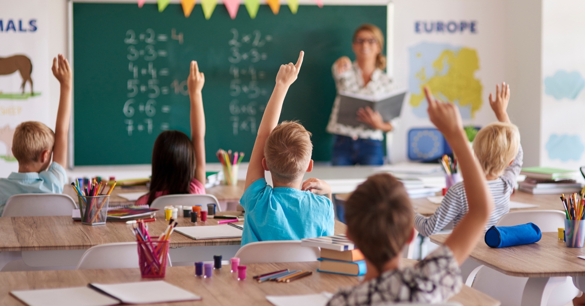 students raising their hands