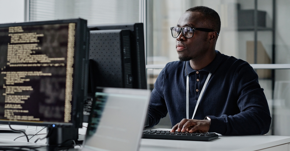 developer in eyeglasses concentrating on his online work