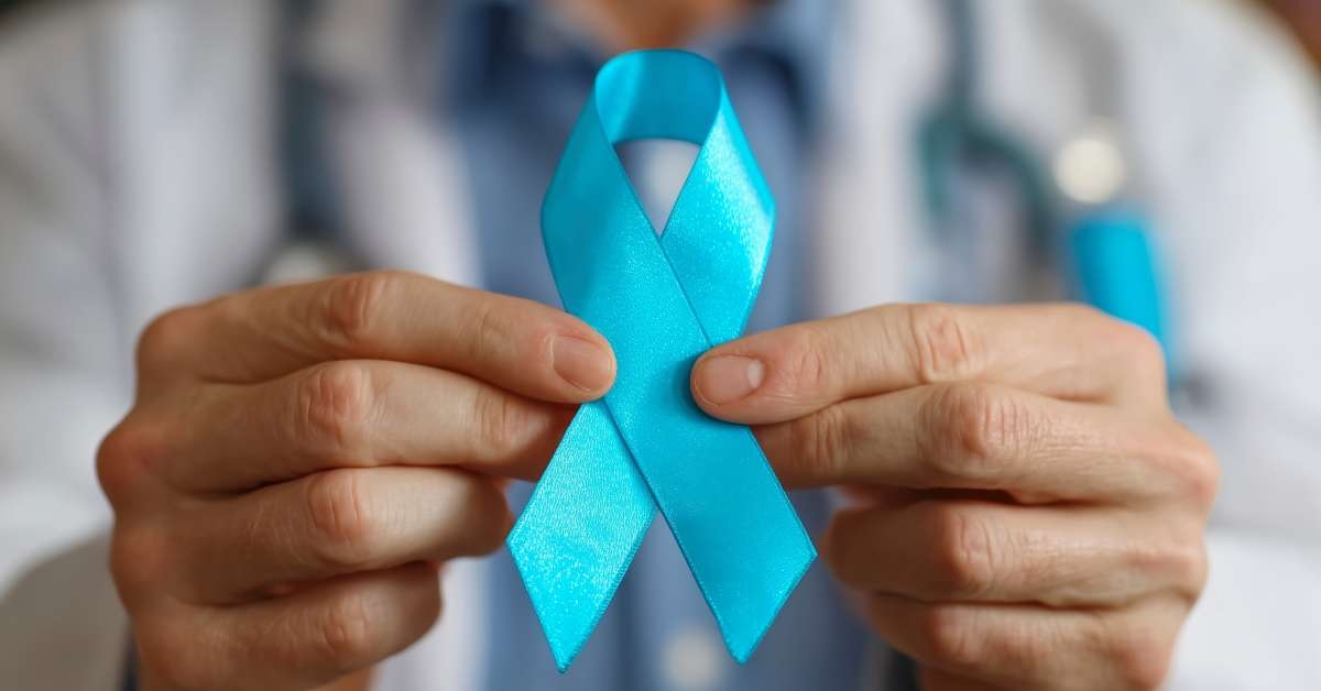 a doctor holds a blue ribbon