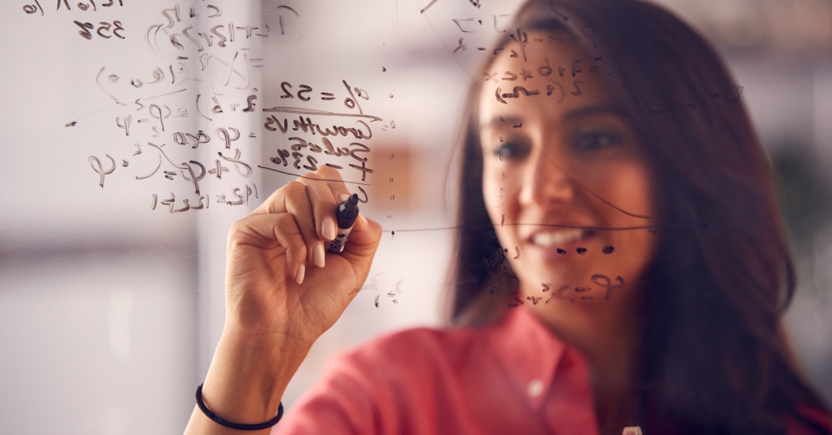 businesswoman calculating on glass screen
