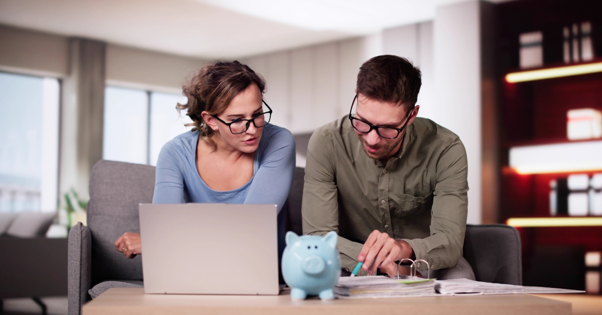 couple at home planning for saving money