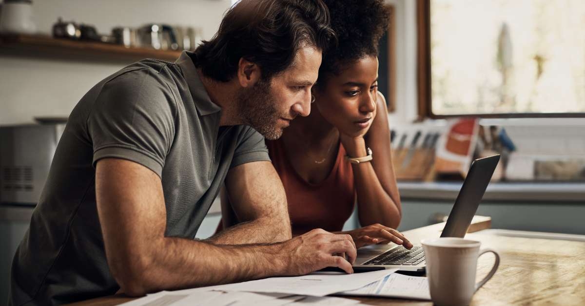 couple with a laptop doing finance paper work