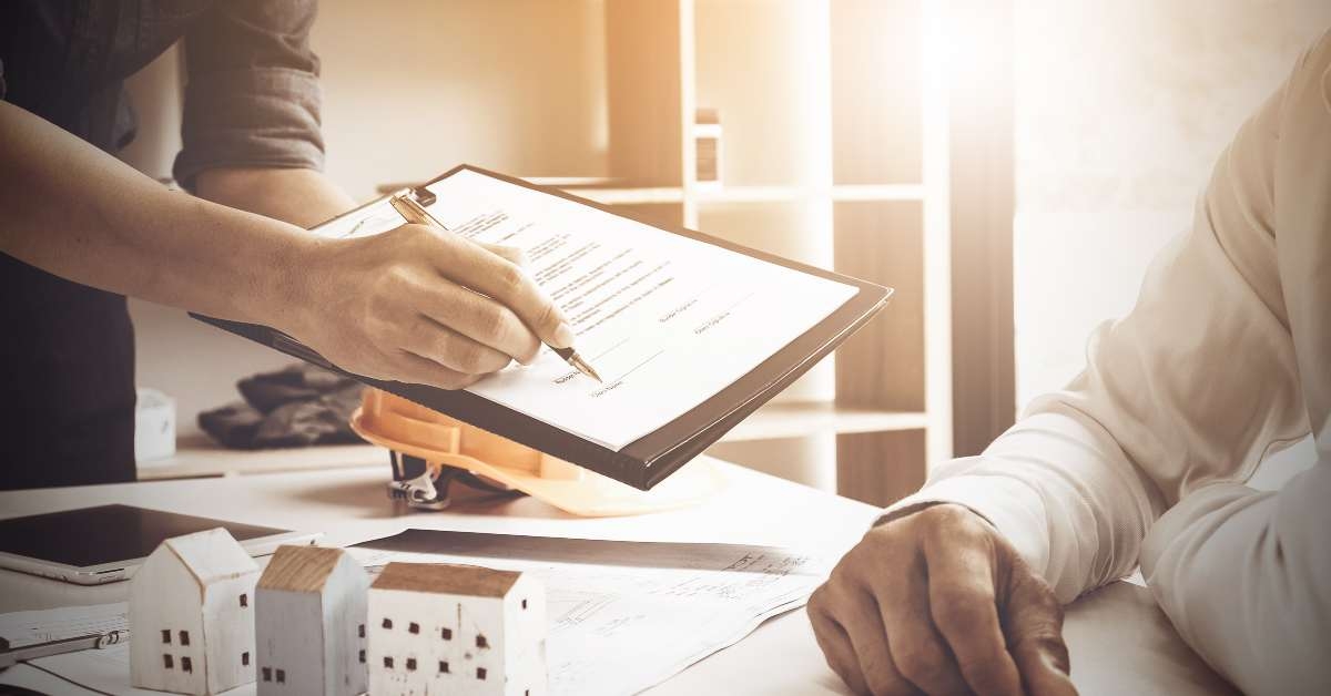 man signing a contract