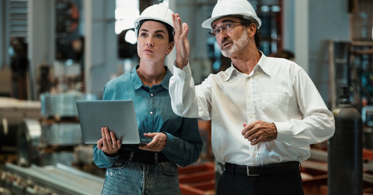 manager inspecting metalwork manufacturing factory