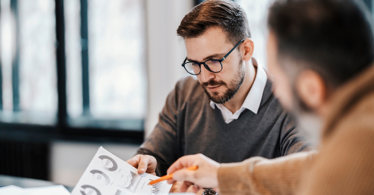 colleagues discussing charts and statistics