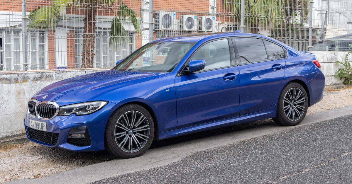 Shiny blue bmw 3 series sedan parked on the street