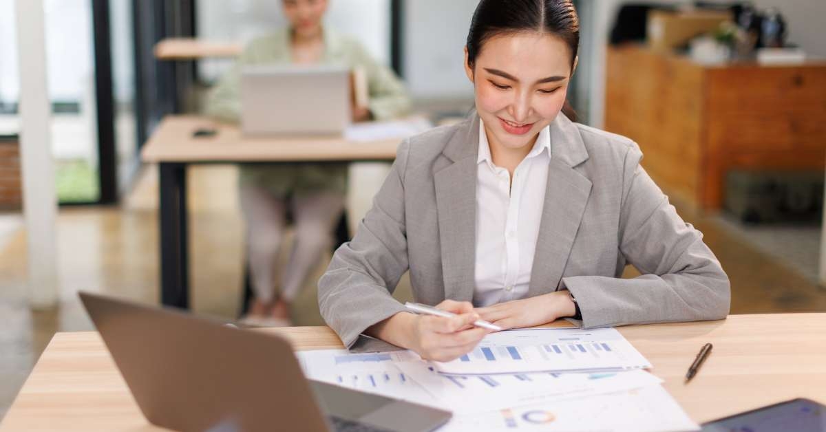 woman sitting at office working on laptop