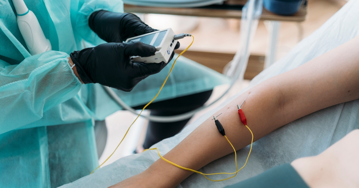 Doctor performing examination using needle electrodes