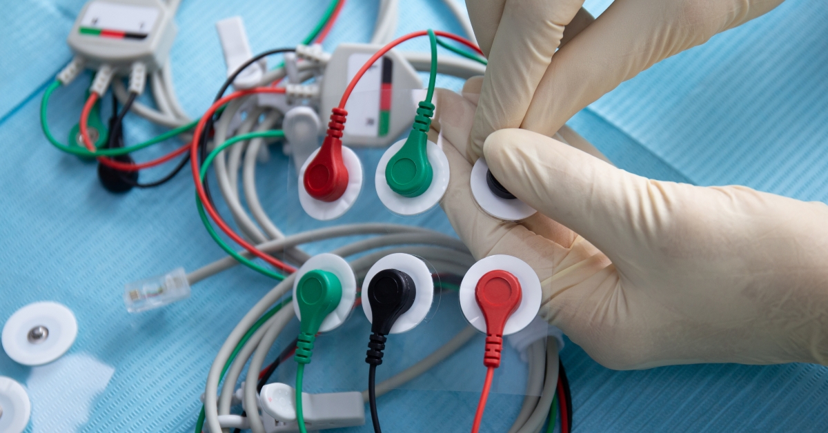 Hands in a gloves connect electrodes
