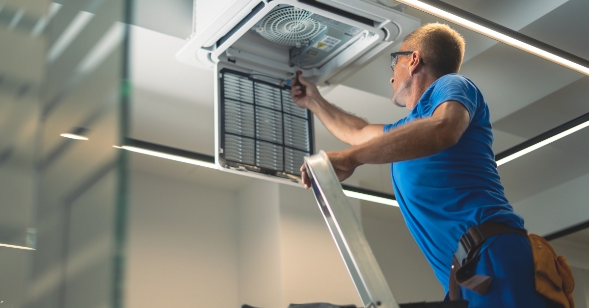 Technical maintenance worker repairs the air conditioning system