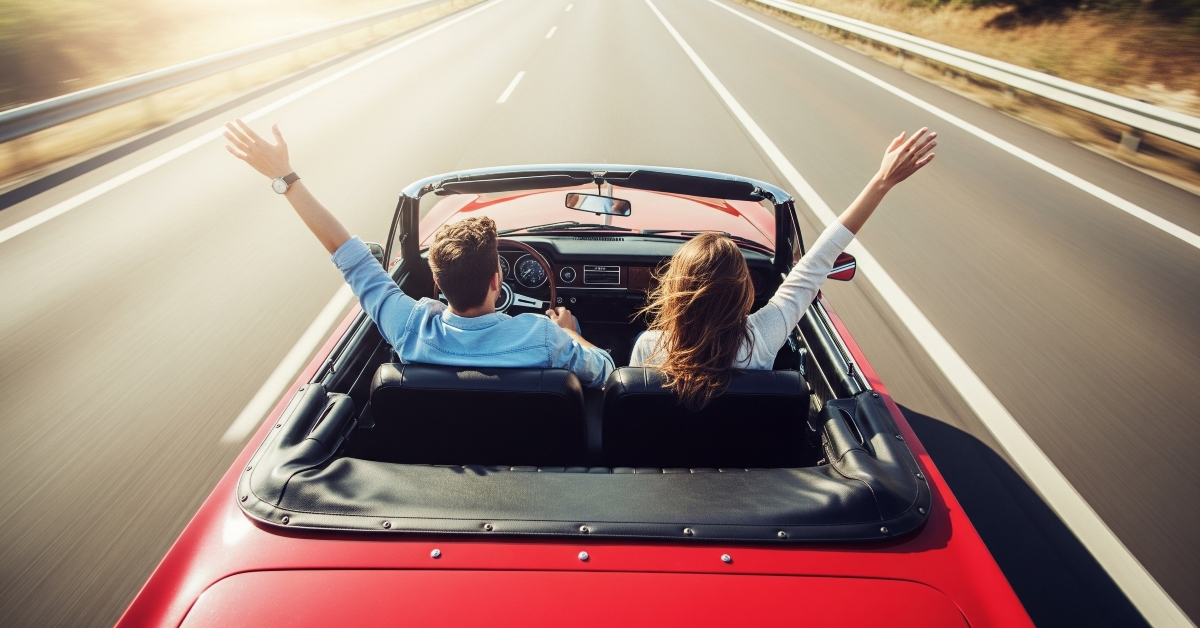 two people in open-top car