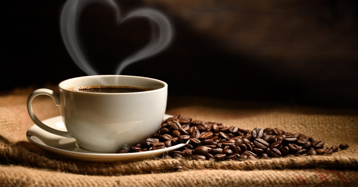 Cup of coffee with heart shape smoke