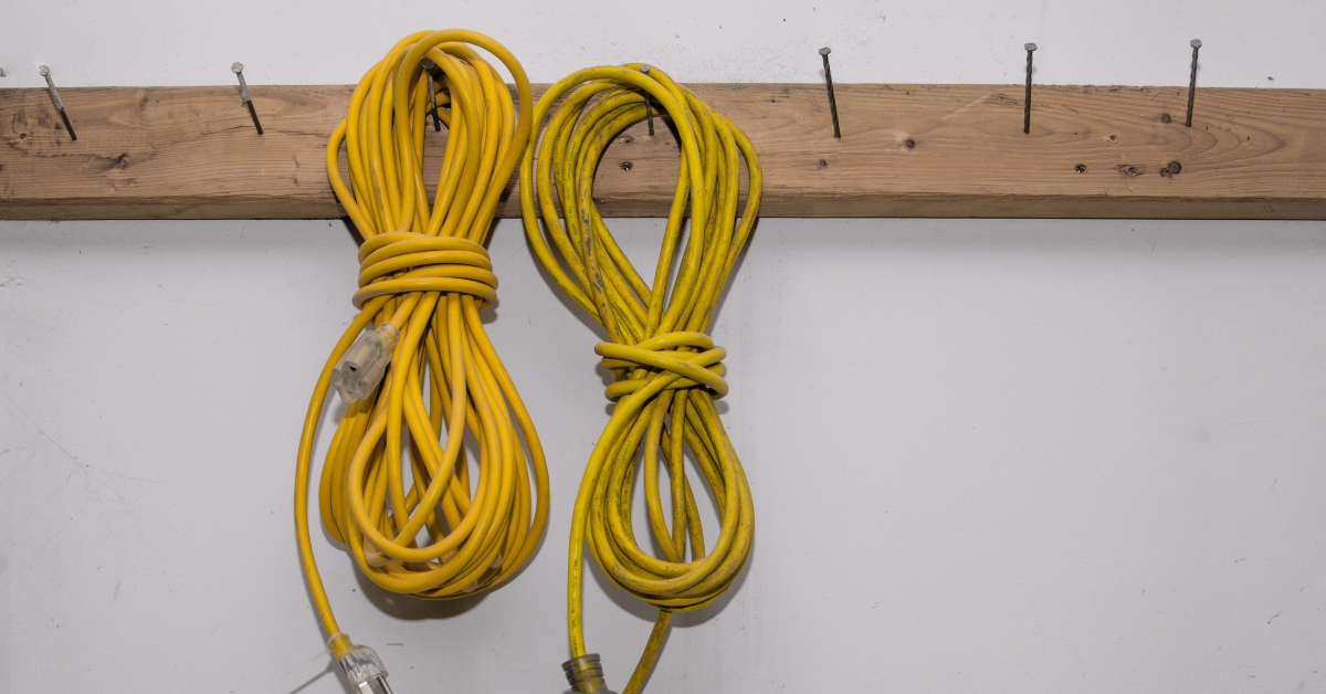Two yellow electrical extension cords hanging