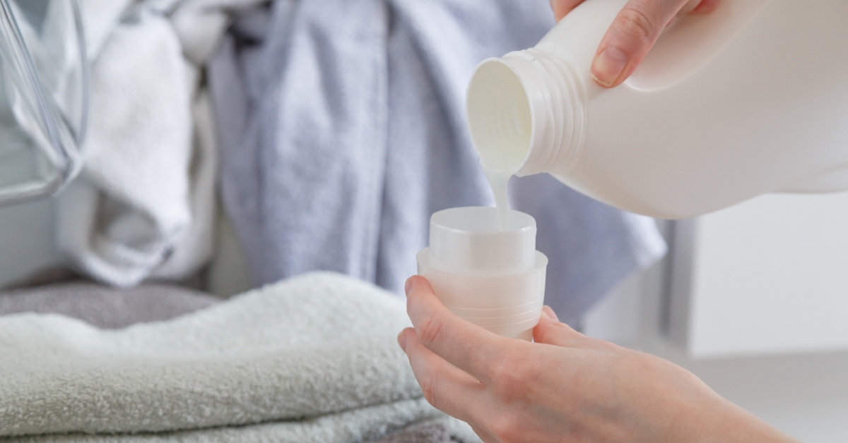 Close up of female hands pouring liquid laundry