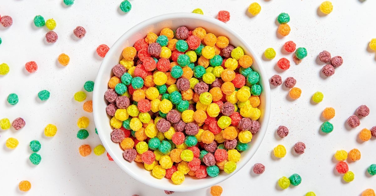 colorful cereals spilling out of white bowl