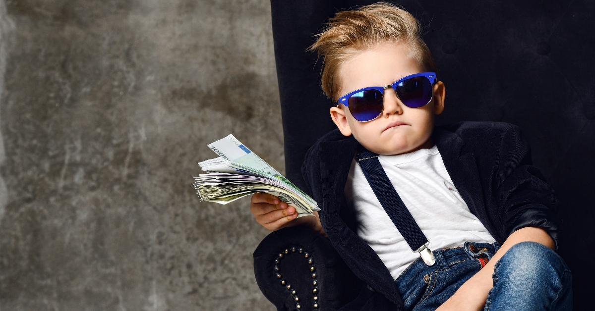 Kid in sunglasses holding money