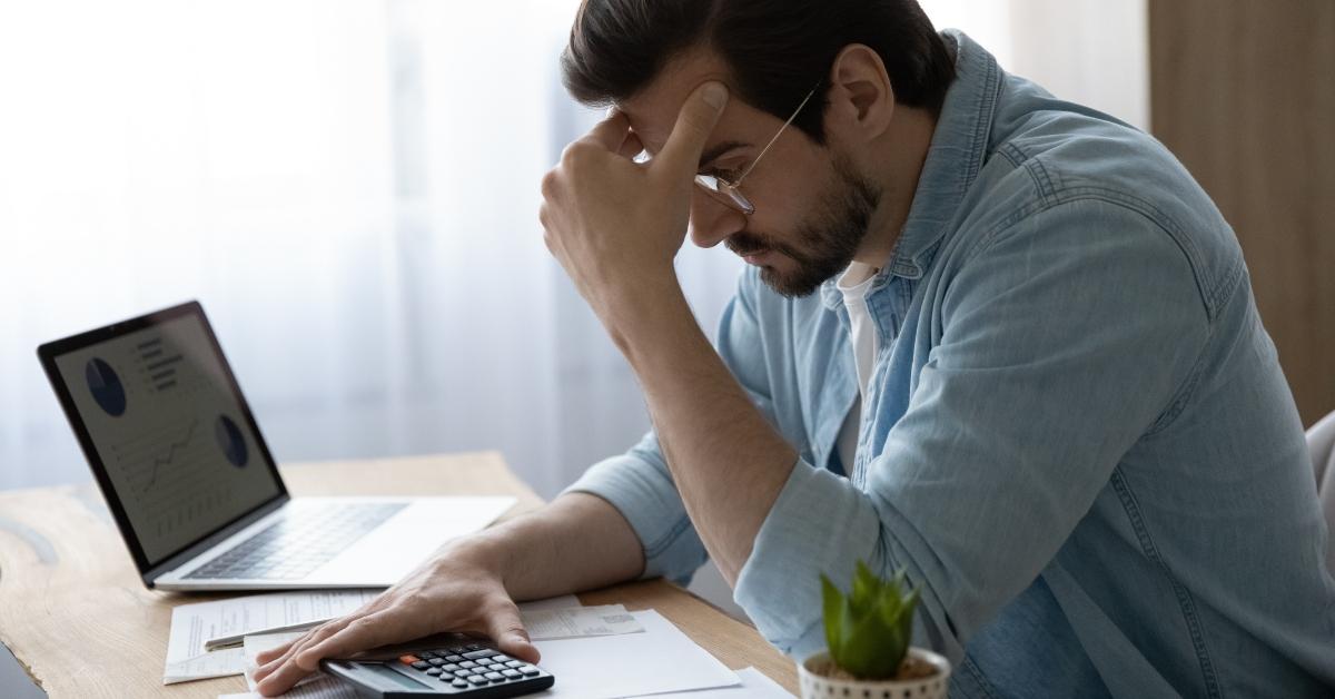 Stressed man with calculator