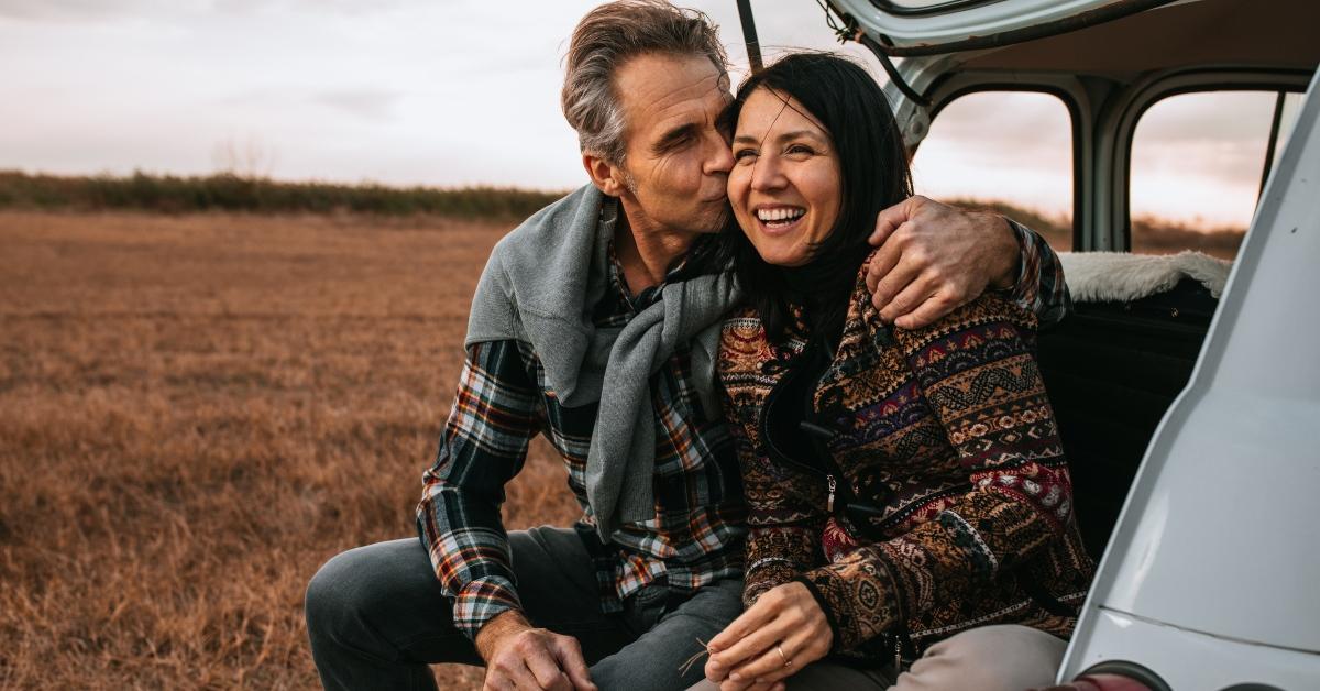 Couple sitting on car