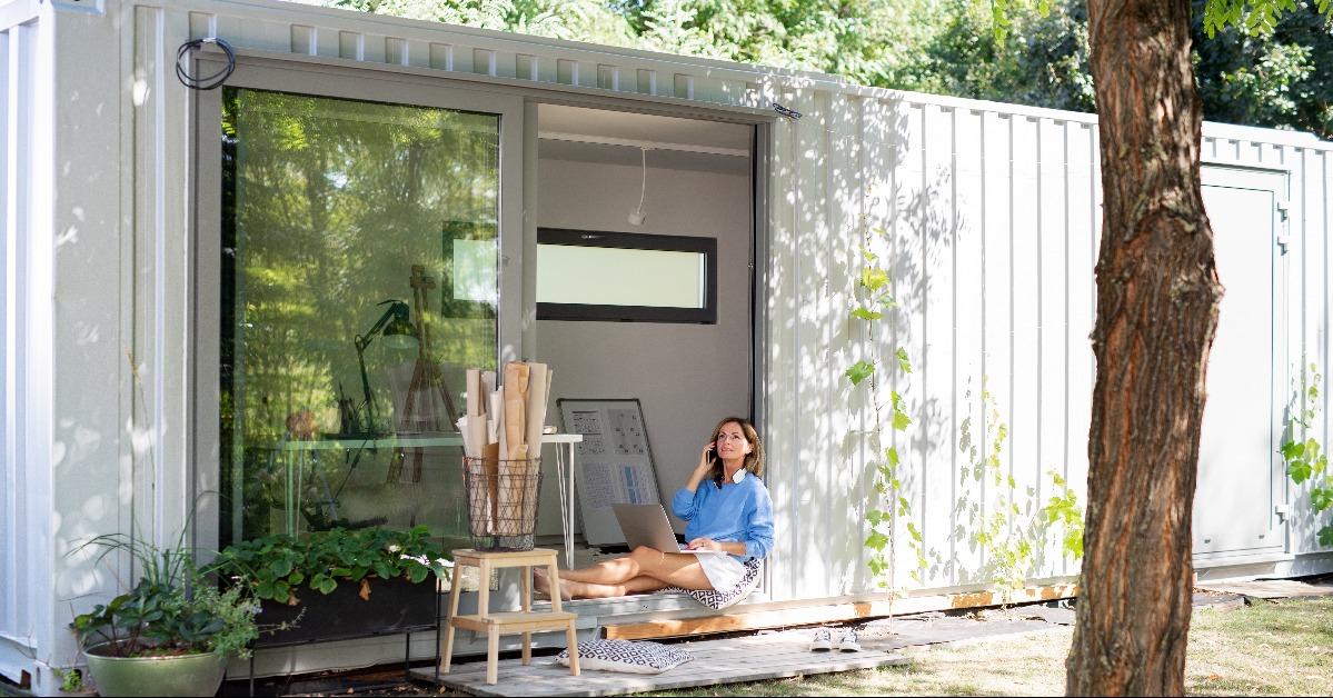 mature woman working in a shipping container house