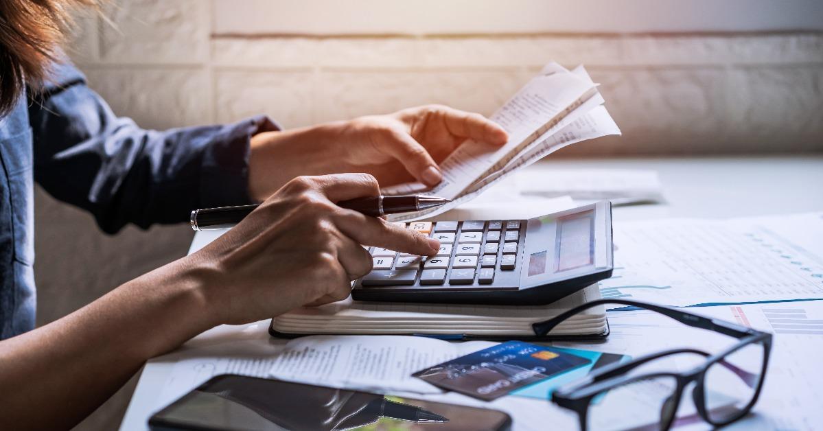stressed young woman checking bills