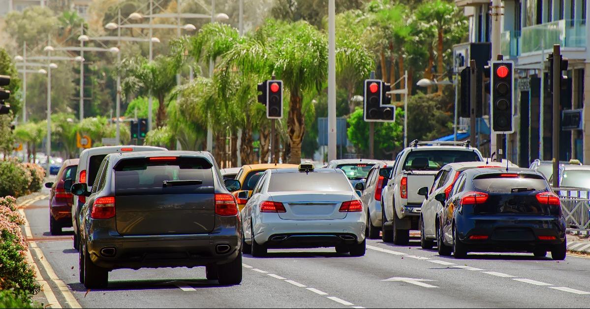 cars stopped at a red traffic light signal