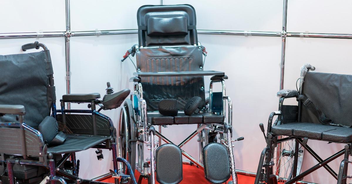 three wheelchairs on a stand in a store