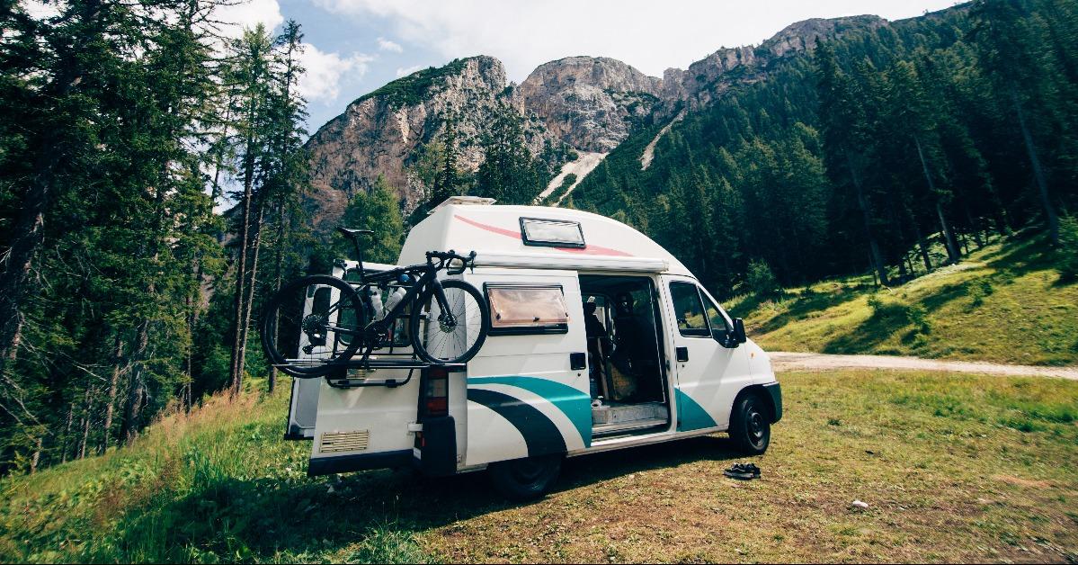 camping RV parked in wild camping spot in mountain forest