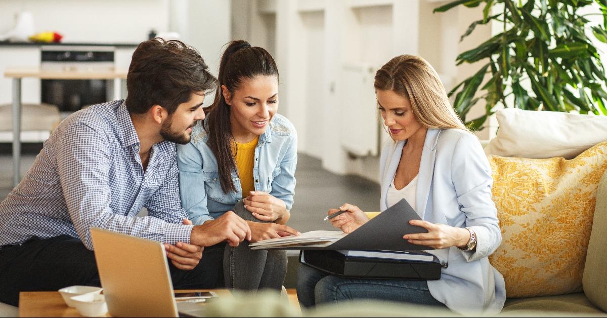 female Real Estate agent offer home ownership and life insurance to young couple