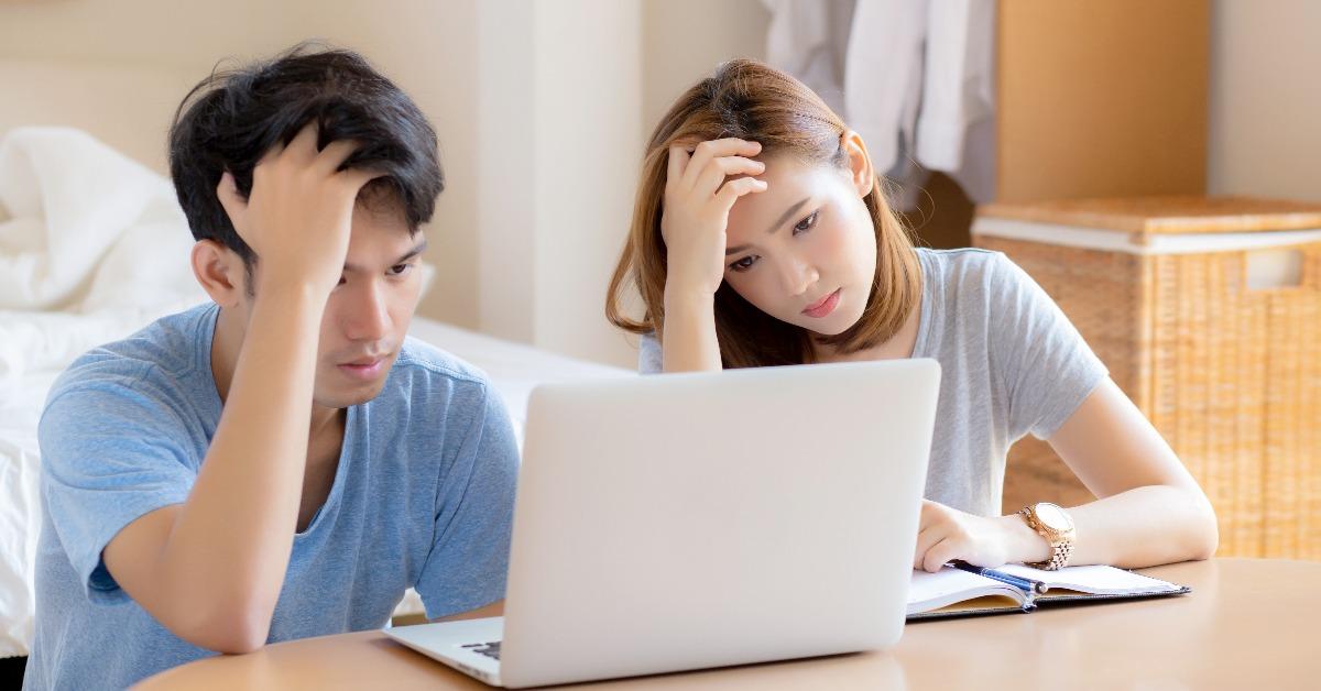 young asian couple stressed and worried about finance