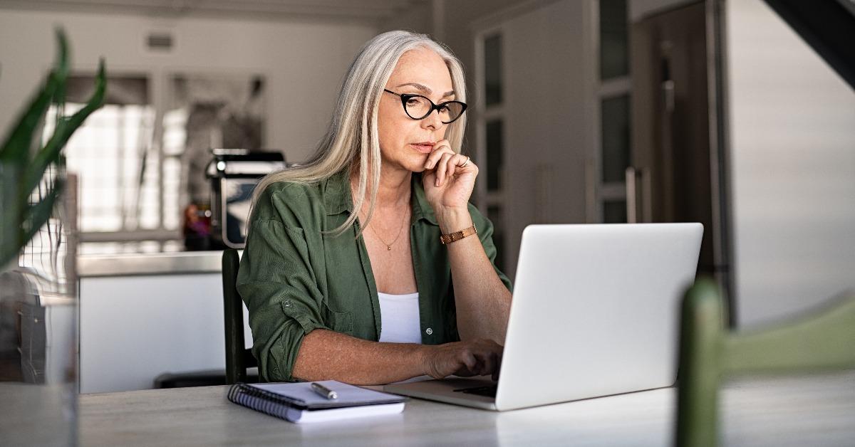 worried senior woman using laptop