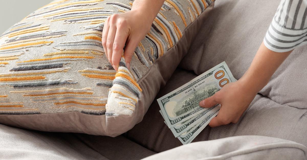 hand hiding dollar banknotes