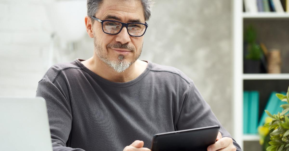 bearded man working online with laptop computer