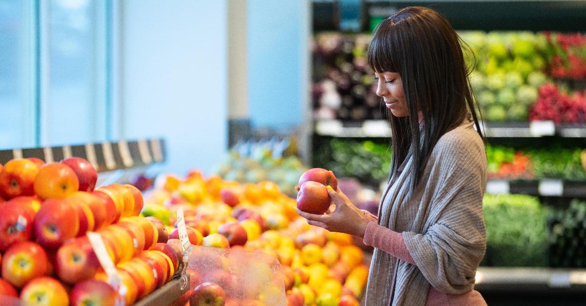 African American woman shopping for produce in grocery store