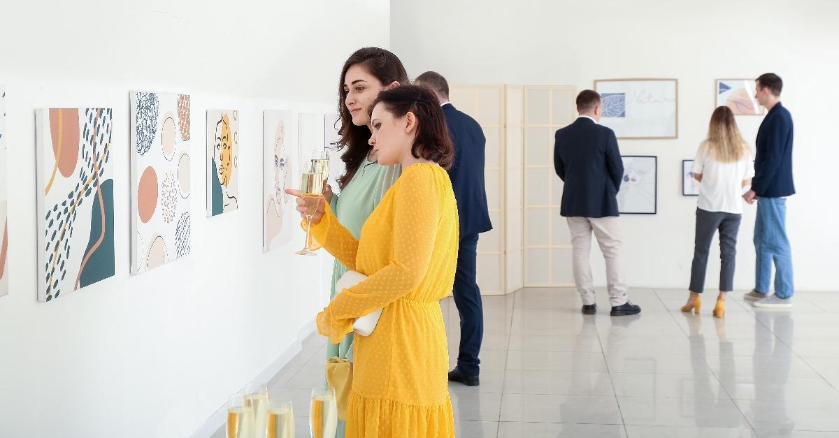 people at exhibition in modern art gallery