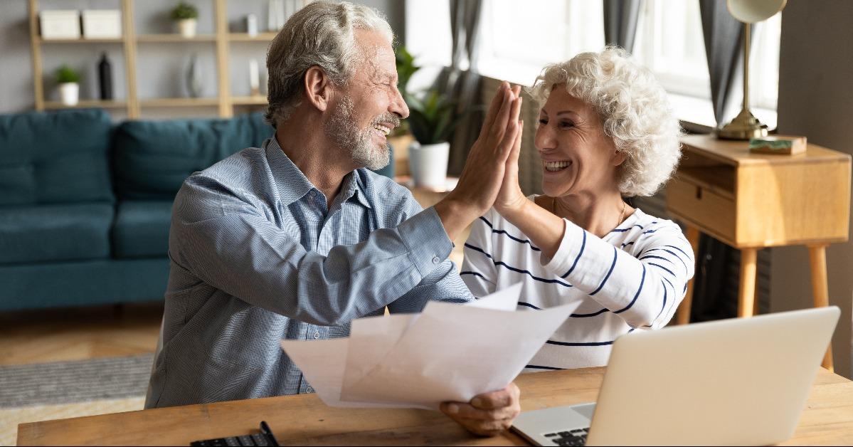 senior married couple giving high five