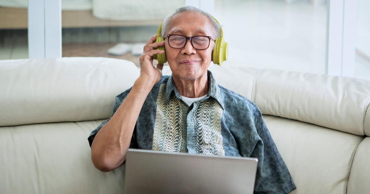 old man listening to music with headphones
