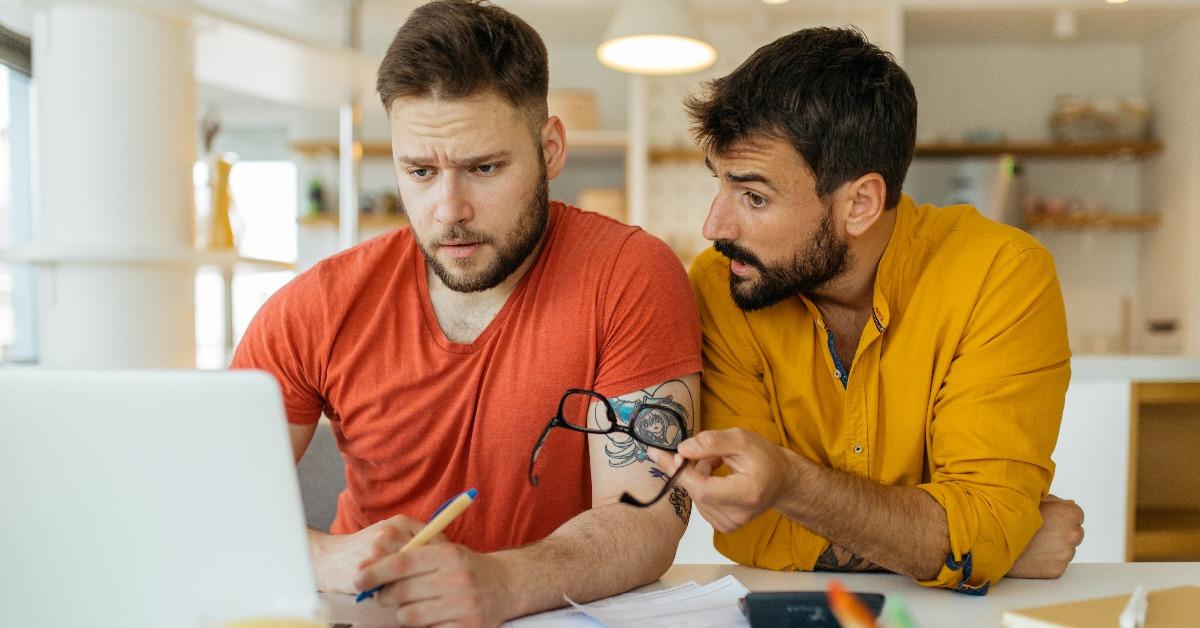 gay couple calculating their monthly income