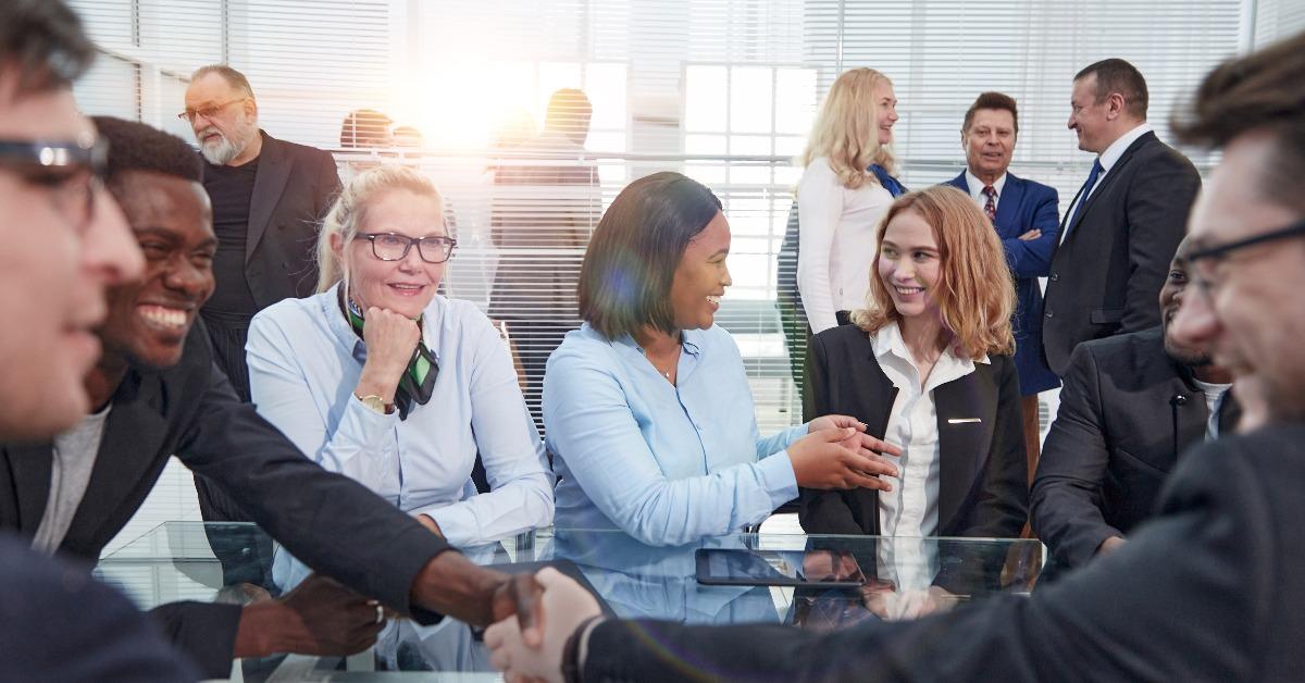 beautiful business people talking and smiling during a conference