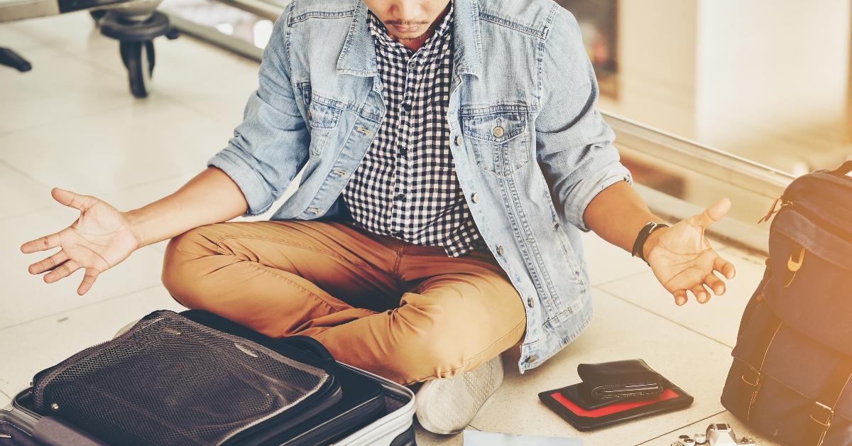 Stressed man looking through luggage