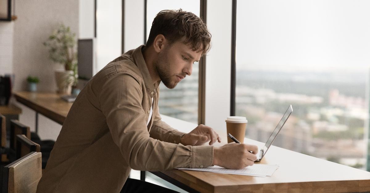 Man working on computer in cafe