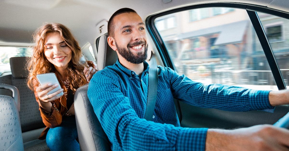 driver sitting in a car with female passenger