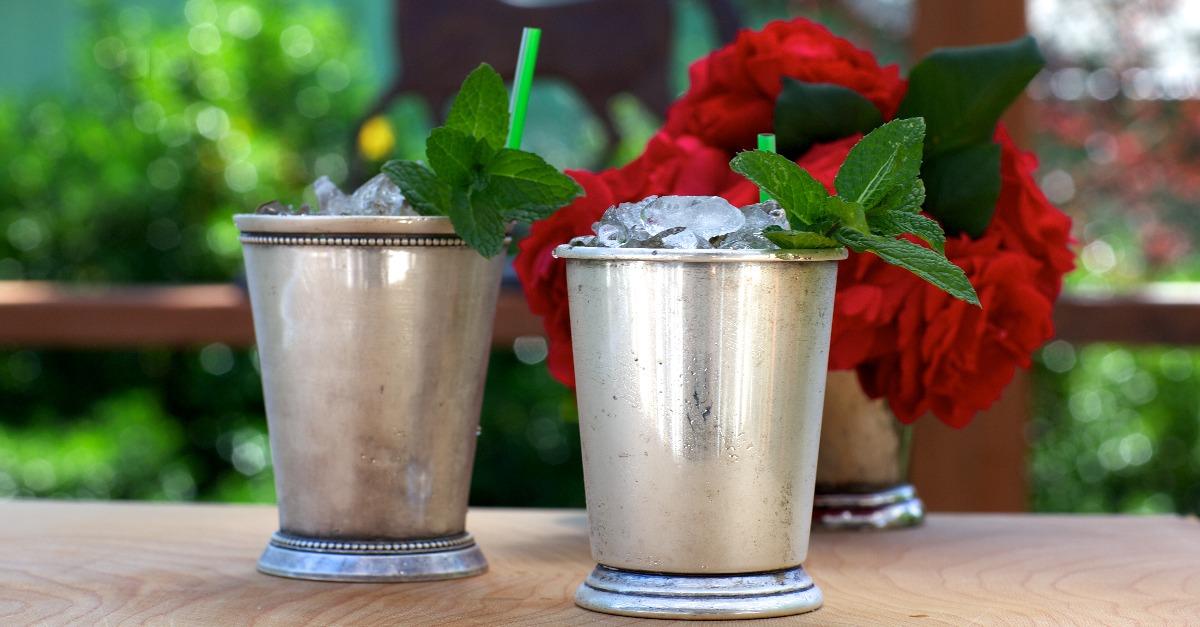 mint julep drinks in silver cups with red roses