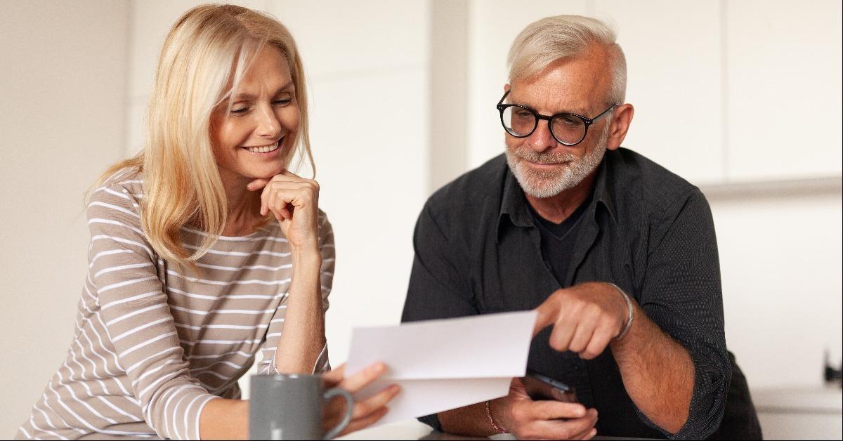 mature husband and wife read a letter